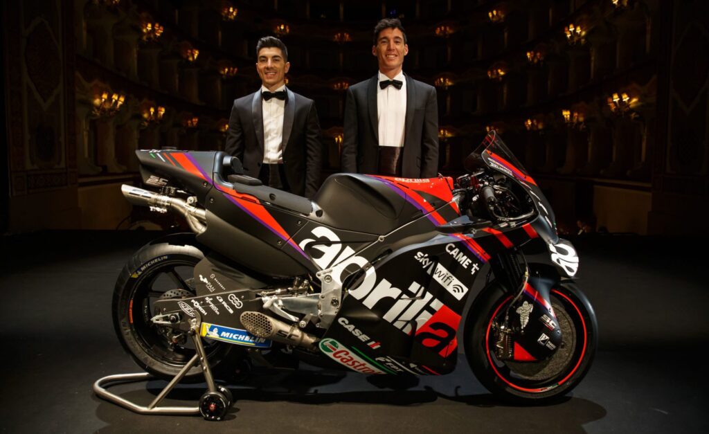 Maverick Vinales (left) and Aleix Espargaro (right) with an Aprilia RS-GP MotoGP racebike at the team