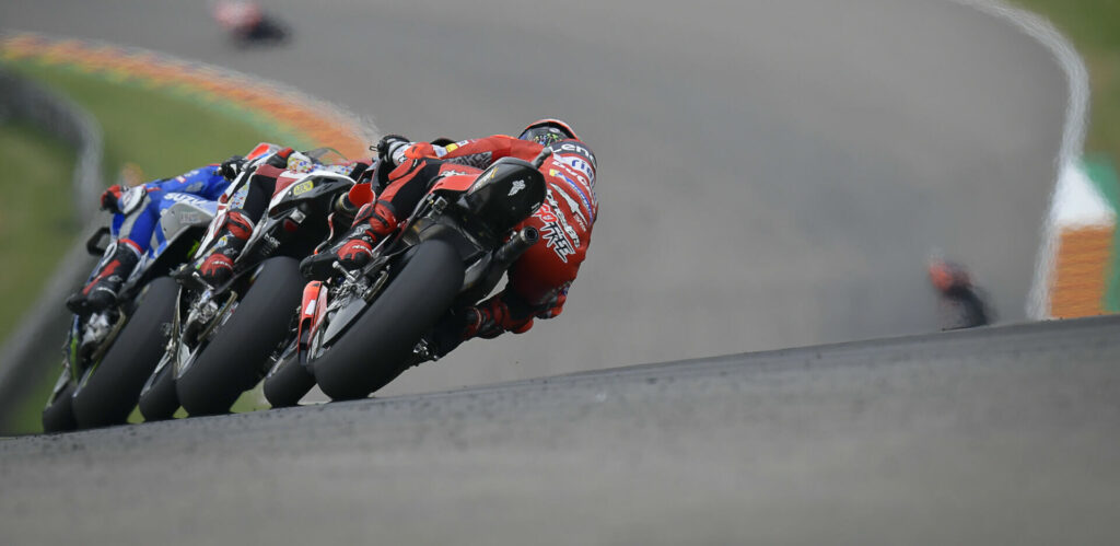 Alex Rins leads Takaaki Nakagami and Francesco Bagnaia at Sachsenring in 2021. Photo courtesy Dorna.